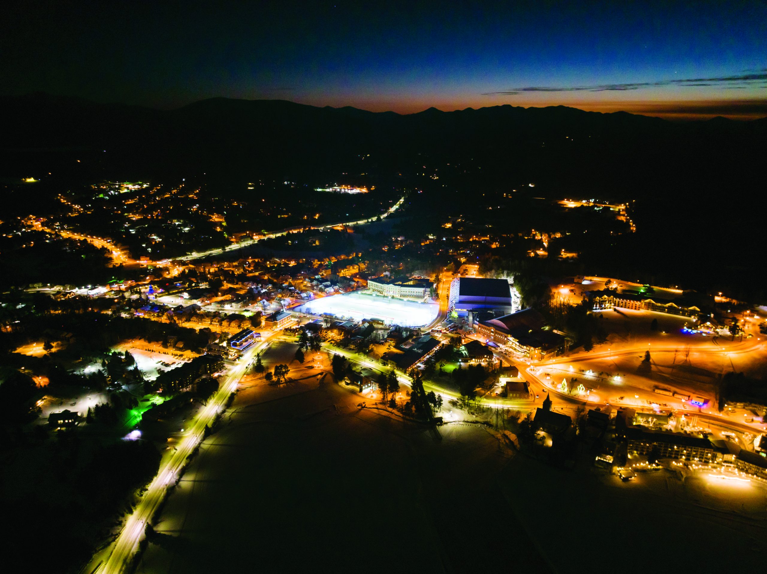 Aerial view of Lake Placid speed skating rink lit up at night