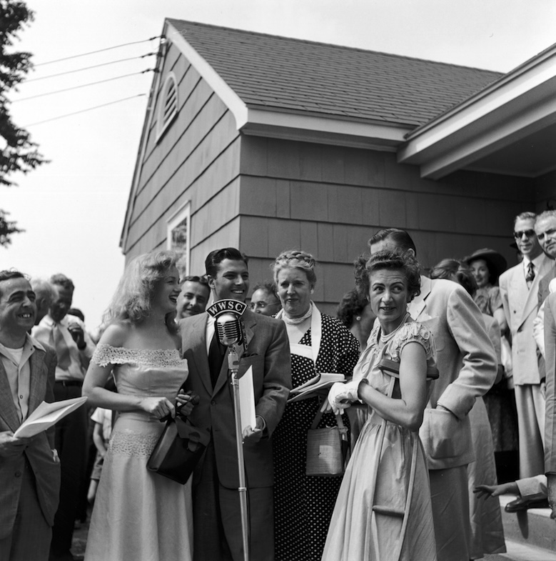 Lucky Winner June 1949: Marilyn Monroe and Don Defore present Photoplay Magazine's 'Dream Home' contest winner, Virginia McAllister, with the key to her new house as a crowd looks on, in Warrenburg, New York.