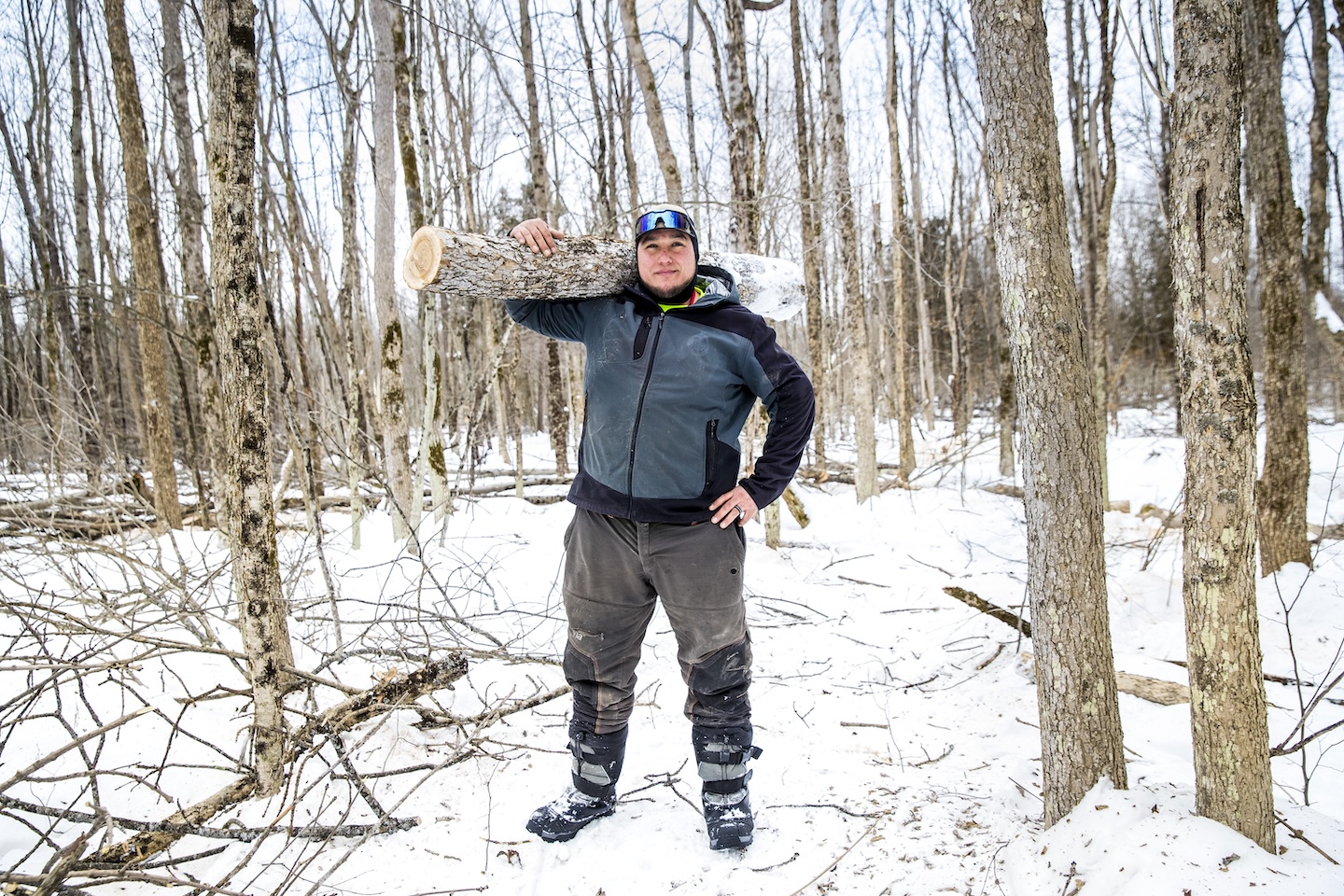 Angello Johnson harvesting ash for baskets in snowy woods.